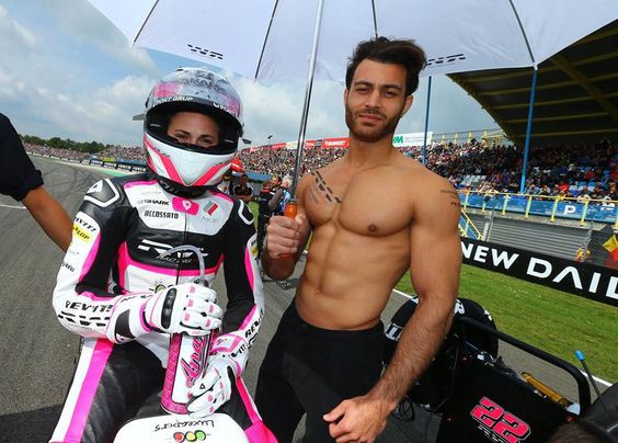 Motorcycle riders usually have umbrella girls on the grid before the race starts